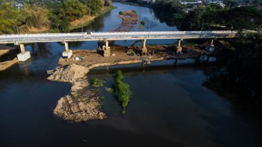 Aerial view of renovation and repair work on the river bridge road.