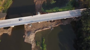 Aerial view of renovation and repair work on the river bridge road.