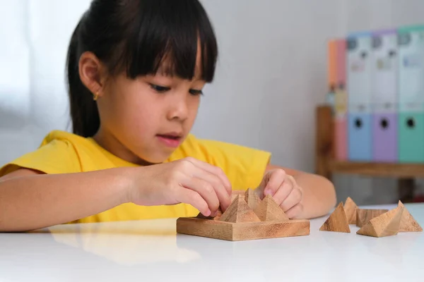 아시아의 귀엽고 소녀가 장난감 피라미드를 테이블 위에서 가지고 있습니다 아이들은 — 스톡 사진