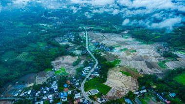 Yağmur mevsiminde doğa vadisinin ortasındaki güzel bir köy manzarası ve Tayland 'ın Loei Eyaleti' nde akan bir nehrin çarpıcı manzarası..