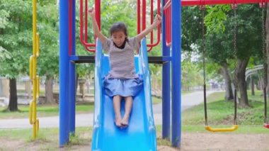 Şirin kız kardeşler parkta salıncakta sallanırken eğleniyorlar. Yaz tatili boyunca oyun bahçesinde oynayan çocuklar.