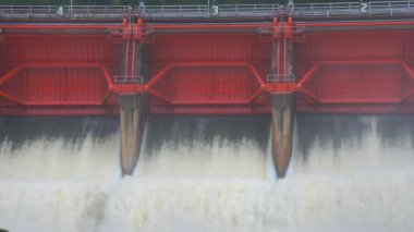 Nehrin aşağısındaki barajın güçlü akım ve kahverengi çamur akıntısıyla sel sularını serbest bırakması.