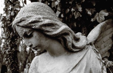 Angel statue close-up in retro style. Angel of death and peace