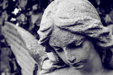 Angel statue close-up in retro style. Angel of death and peace