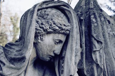 Angel statue close-up in retro style. Angel of death and peace