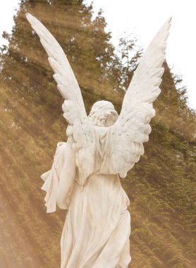 Angel in a sunbeam. Ancient statue