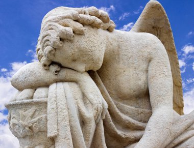 Tired angel warrior resting after battle on sky background