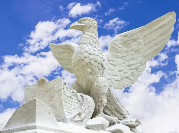 Statue of an eagle with large wings close-up on a sky background. Symbol of freedom and liberty