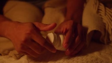 Insomnia night Dark-skinned guy Tired disturbed with anxiety trying to rest in bed with phone.
