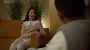 Asian girl with a psychologist, talking mental problems, during psychotherapy.