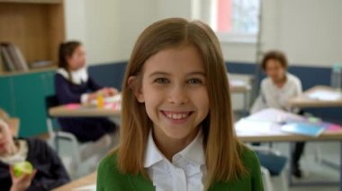 Elementary school class, children communicate with the teacher, answering various questions.