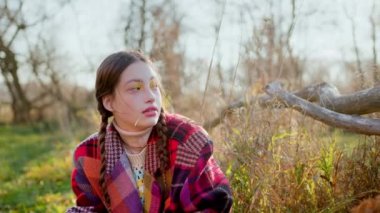 Smiling beautiful teen girl throws up autumn leaves in the park in slow motion. High quality 4k footage