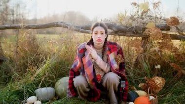 Smiling beautiful teen girl throws up autumn leaves in the park in slow motion. High quality 4k footage