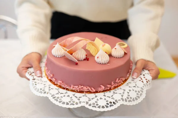 Cake in a woman's hands, sweet cake