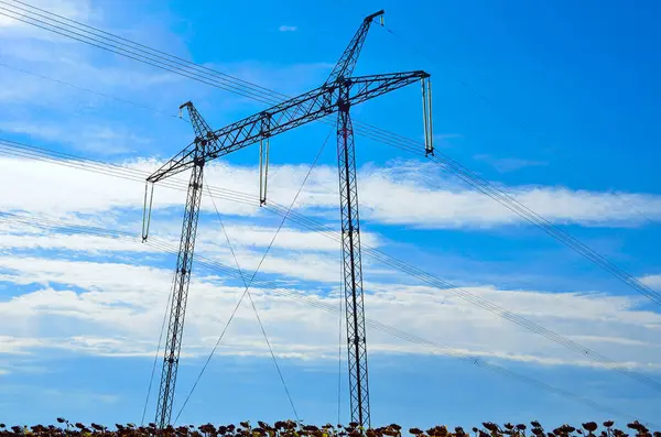 stock image Supports of high voltage lines against the blue sky