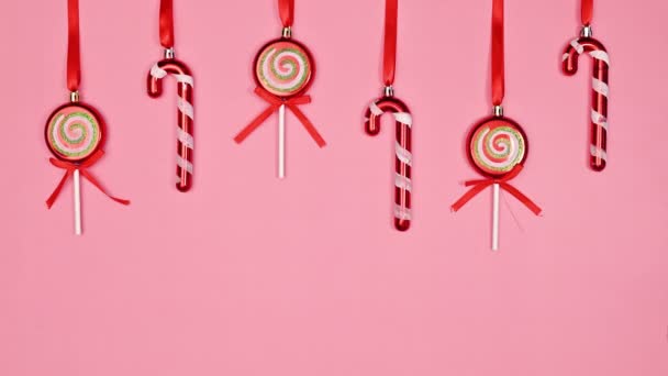 Christmas Candies Hanging Ribbon Pastel Pink Background Copy Space Flat — Vídeo de Stock