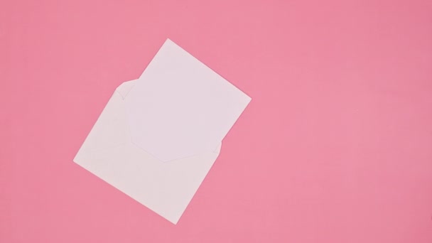 Paper Envelope Christmas Gift Appear Pastel Pink Background Flat Lay — Vídeos de Stock