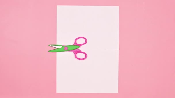 Colorful Scissors Cutting White Paper Pastel Pink Background Stop Motion — Video