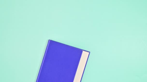Purple Hardcover Book Appear Open Cyan Background Flat Lay Stop — Vídeos de Stock