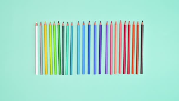 Colorful Pencils Appear Move Cyan Background Flat Lay Stop Motion — Stockvideo