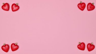 Valentine's day background with moving hearts and copy space on pastel pink background. Stop motion. Flat lay