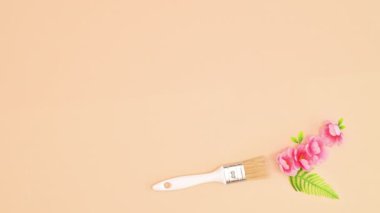 Beautiful floral garland stop motion. Paint brush leaving behind bloom spring flowers. Flat lay
