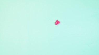 Creative stop motion animation with strawberry glazed donut and woman hand taking donut on pastel blue background. Flat lay. Stop motion. Food concept