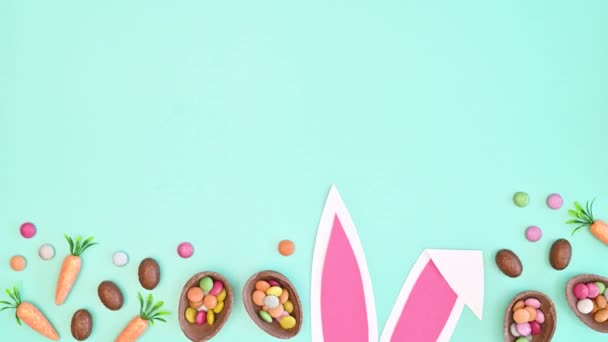 Easter Arrangement Bunny Ears Chocolate Eggs Bottom Pastel Blue Background — Stockvideo