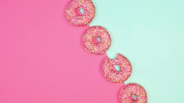 Creative Two Colored Copy Space Background Rotating Strawberry Glazed Donuts — Stock video