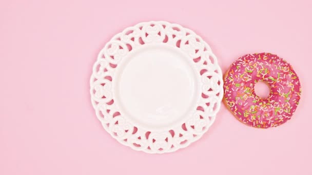 Eating Delicious Sweet Strawberry Glazed Donut White Plate Pastel Pink — Vídeo de stock