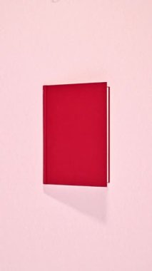 Kırmızı romantik klasik kitap okaliptüs yapraklı pastel pembe arka planda görünür ve açılır. Dikey durma hareketi