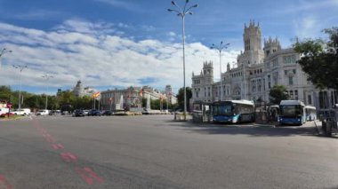Şehir caddesinde park edilmiş bir otobüs var, arkaplan olarak güzel bir Avrupa binası var. Bu görüntüler modern ulaşım ve klasik Avrupa mimarisi ile şehir yaşamı, şehir manzaraları ve toplu taşıma projeleri için ideal olan karışımı yakalar.. 