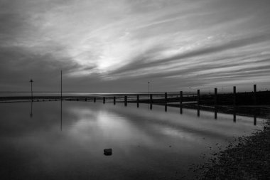 Black and white image of  Westcliff beach, near Southend-on-Sea, Essex, England, United Kingdom