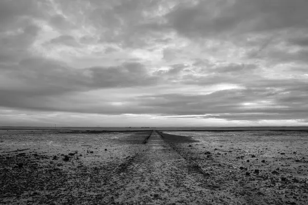 stock image Black and white image of a pathway on the beach at Westcliff, Essex, England, United Kingdom 