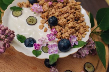 Granola - a healthy breakfast dish, as well as a traditional snack of rolled oatmeal, nuts and honey, with yogurt and fruit