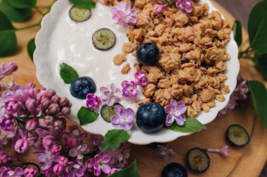 Granola - a healthy breakfast dish, as well as a traditional snack of rolled oatmeal, nuts and honey, with yogurt and fruit