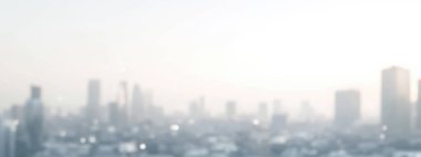 A blurred city skyline during the early morning, creating a serene and dreamy atmosphere. clipart