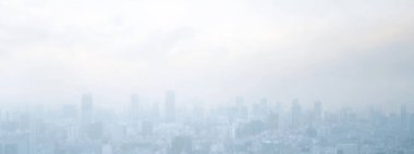 Foggy skyline view with muted colors, creating a serene urban atmosphere. clipart