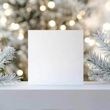 Empty white card surrounded by festive greenery and soft lights. clipart