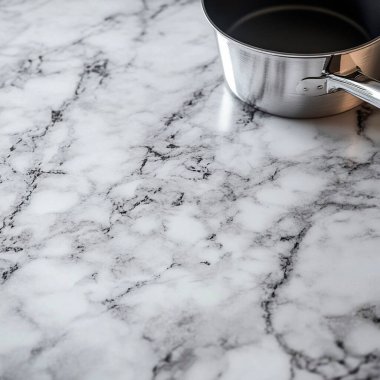 Close-up of a marble countertop with a stainless steel saucepan. clipart