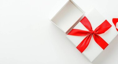 White gift box with a red ribbon, partially open, on a minimalistic background. clipart