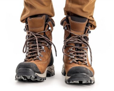 Sturdy brown hiking boots worn by a male adventurer, ready for the great outdoors. clipart