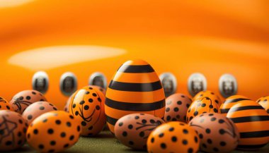 Colorful Easter eggs in vibrant orange hues create a festive atmosphere for the holiday. clipart