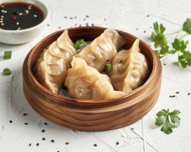 Savory dumplings served in a wooden steamer, garnished with green onions and accompanied by dipping sauce. clipart