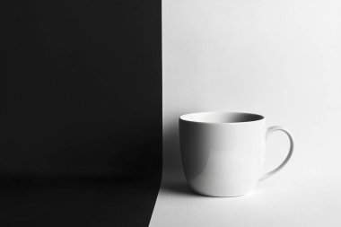 Minimalist Coffe Cup on Black and White Split Surface  Clean and Elegant Design clipart