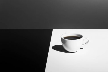 Minimalist Coffe Cup on Black and White Split Surface  Clean and Elegant Design clipart