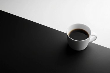 Minimalist Coffe Cup on Black and White Split Surface  Clean and Elegant Design clipart