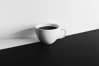 Minimalist Coffe Cup on Black and White Split Surface  Clean and Elegant Design clipart