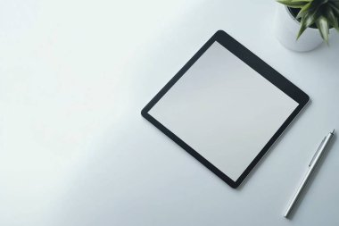 Minimalist Tablet and Pen Mockup on a Clean White Desk with Plant clipart