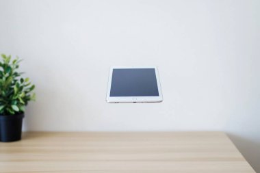 Minimalist Tablet and Stylus on Clean White Desk - Perfect for Graphic Designers